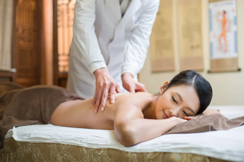 Young woman receiving chinese massage